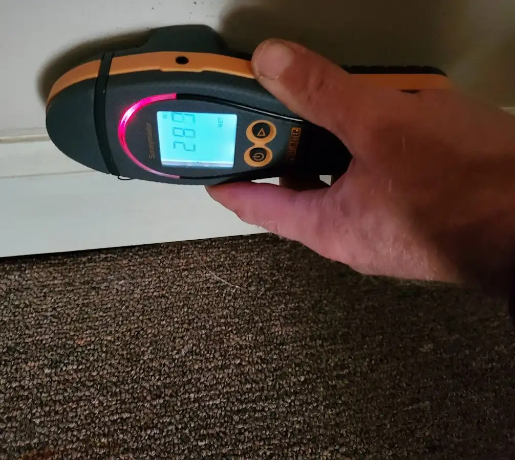 Moisture detection at baseboard during Storm Damage Restoration in Metropolis